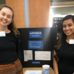 Two GCPR students presenting their practicum poster at an event..